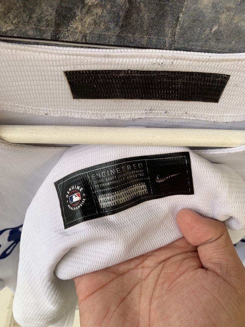 Nike Los Angeles Dodgers Baseball Jersey (Category: Tshirts & Polo Shirts ) located in Manila. Submitted by gelove.thrift (Listing ID 1434808202, Image 2). Description: - Authentic Nike Los Angeles Dodgers baseball jersey - Features the Dodgers logo and "ROCHA" on the front - Made with breathable, textured fabric - Includes Nike and MLB logos - Button-up front and short sleeves - Size tag is visible - Minor tear on the side.