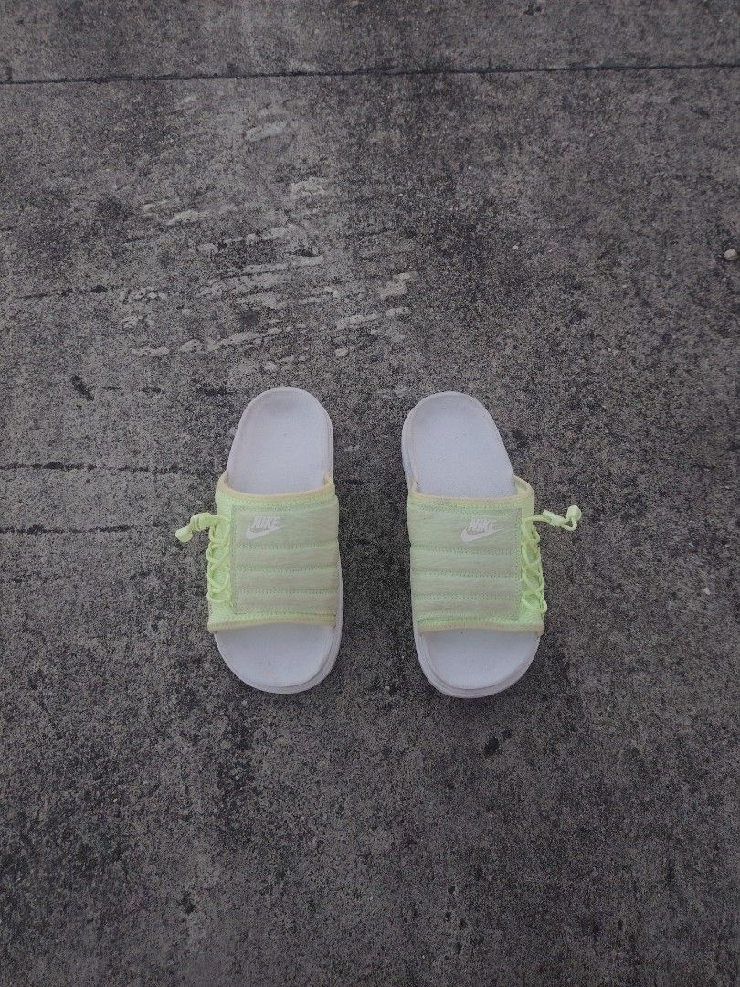 Nike Women's Slides (Category: Slippers and slides) located in Calapan. Submitted by thriftopia_12 (Listing ID 1434943685, Image 1). Description: - Nike slides - Light green quilted strap - White sole - Size: US 8, EUR 39 to 40, 25 cm - Made in Vietnam - Nike logo visible - Ideal for casual wear.