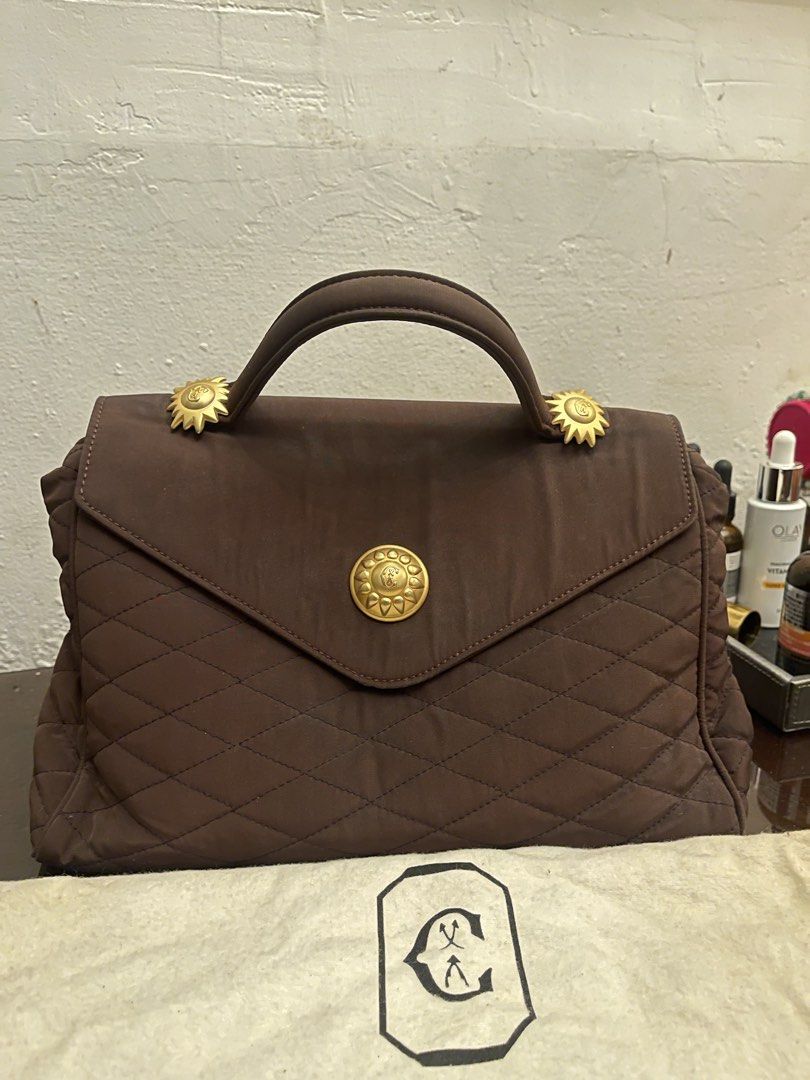 Philippe Charriol Brown Quilted Handbag (Category: Luxury Bags & Wallets) located in Marilao. Submitted by wardrovearchives (Listing ID 1434938188, Image 1). Description: - Philippe Charriol handbag - Elegant brown color - Quilted design - Top handle - Gold-toned accents - Includes matching dust bag - Lined interior with zipper pocket - Made in Italy.