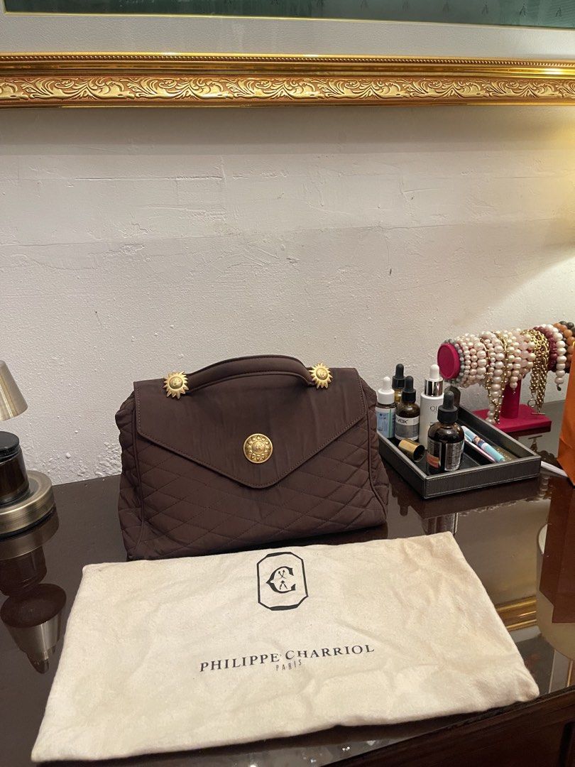 Philippe Charriol Brown Quilted Handbag (Category: Luxury Bags & Wallets) located in Marilao. Submitted by wardrovearchives (Listing ID 1434938188, Image 2). Description: - Philippe Charriol handbag - Elegant brown color - Quilted design - Top handle - Gold-toned accents - Includes matching dust bag - Lined interior with zipper pocket - Made in Italy.