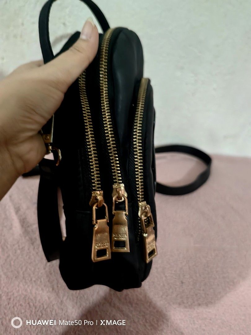 Prada Black Teddy Bear nylon Backpack (Category: Luxury Bags & Wallets) located in Villasis. Submitted by mysticforest.bb2b4b (Listing ID 1434895676, Image 2). Description: - Black backpack with teddy bear design - Multiple zippered compartments - Top handle - Detachable strap for shoulder or crossbody wear - Prada branded interior - Gold-toned zippers.