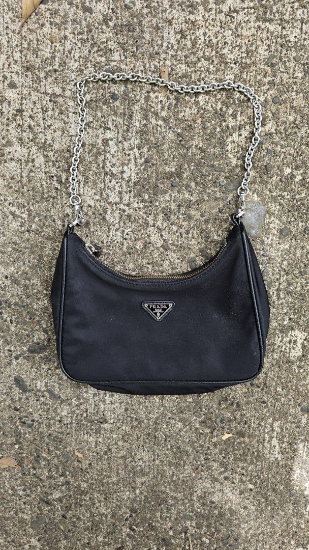 Prada Re-Edition 2000 Mini Bag (Category: Luxury Bags & Wallets) located in Kibawe. Submitted by Thrift_ni_Babac (Listing ID 1434945283, Image 1). Description: - Prada Re-Edition 2000 mini bag - Color: Black - Material: Nylon - Strap: Silver chain - Closure: Zip with Prada logo - Features Prada logo on front - Interior: Prada Milano label Excellent Condition.