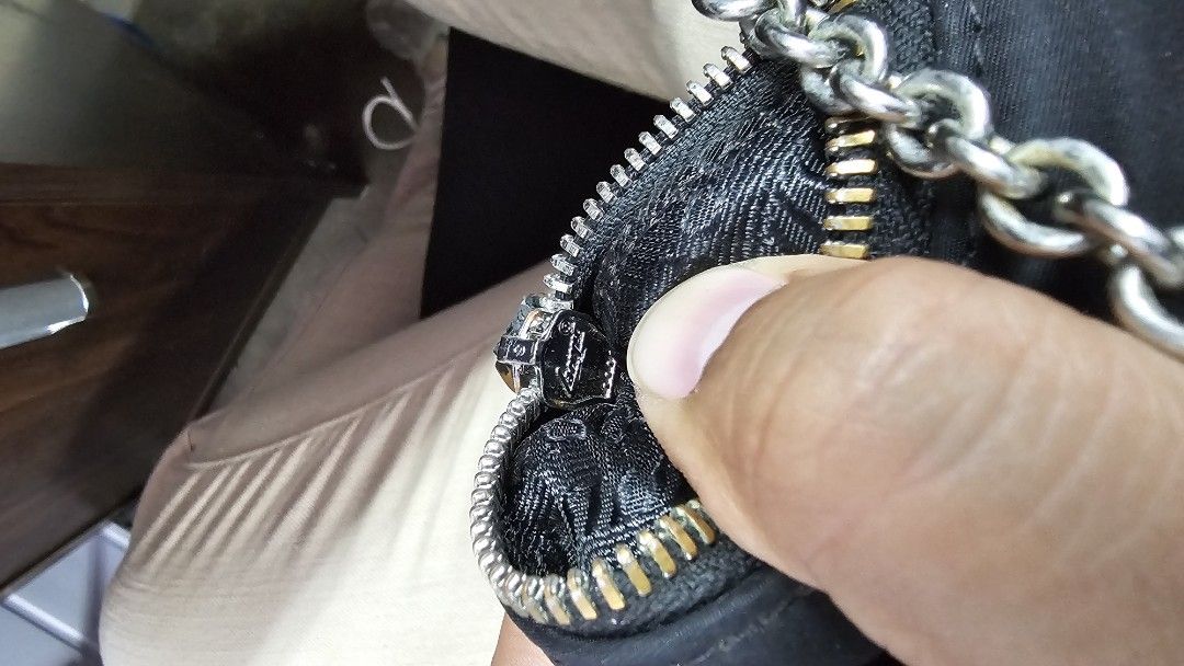 Prada Re-Edition 2000 Mini Bag (Category: Luxury Bags & Wallets) located in Kibawe. Submitted by Thrift_ni_Babac (Listing ID 1434945283, Image 3). Description: - Prada Re-Edition 2000 mini bag - Color: Black - Material: Nylon - Strap: Silver chain - Closure: Zip with Prada logo - Features Prada logo on front - Interior: Prada Milano label Excellent Condition.