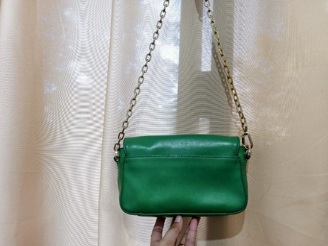 Preloved Tory Burch Mint Green Sling Bag (Category: Luxury Bags & Wallets) located in Manila. Submitted by findswithalcloset (Listing ID 1434912722, Image 2). Description: - Authentic Tory Burch sling bag - Color: Mint Green - Features chain strap - Flap closure with Tory Burch logo - Flaw: Minor color fading and slight discoloration (not very noticeable when worn); nahati na din yung jelly tag nya, nalaglag na yung kalahati kya dko na nakita - R
