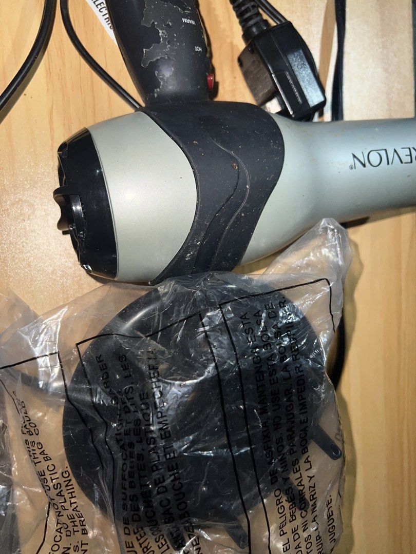 Revlon Hair Dryer with Diffuser (Category: Hair) located in Manila. Submitted by jeimisan (Listing ID 1434995337, Image 3). Description: - Revlon hair dryer with diffuser attachment. - Multiple heat settings: Cool, Warm, Hot. - Stylish silver and black color scheme. - Includes a black power cord and plug. - Diffuser attachment is unused. 110 V.
