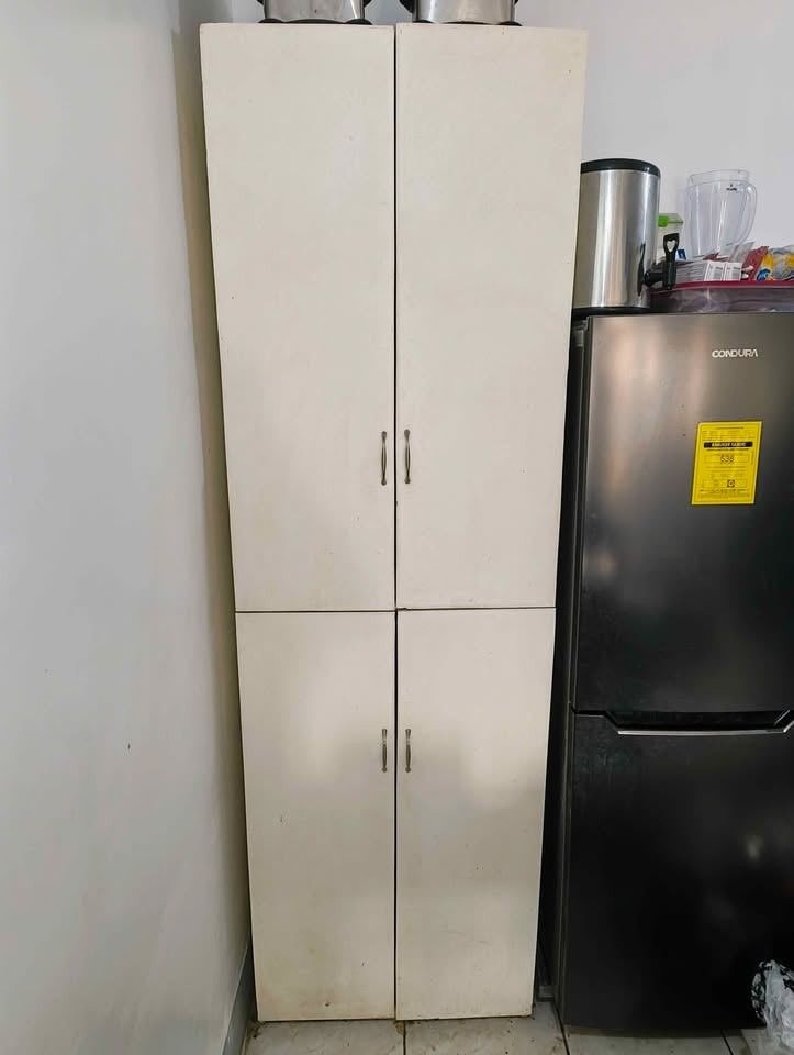 Tall White Cabinet with Shelves (Category: Shelves, Cabinets & Racks) located in Meycauayan. Submitted by kocoshibo07 (Listing ID 1434868867, Image 1). Description: - Tall white wooden cabinet - Features four doors - Includes multiple shelves for storage - Suitable for kitchen or other storage needs - Simple and practical design -Heavy Duty Rush Sale! Price Negotiable .