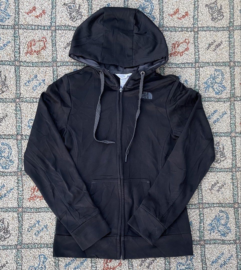 The North Face Black Hoodie Jacket (Category: Coats, Jackets and Outerwear) located in Manila. Submitted by stepsole (Listing ID 1434995575, Image 1). Description: - The North Face black hoodie jacket - Full zip closure - Hood with drawstrings - Two front pockets - The North Face logo on chest - Soft, possibly fleece-lined material -issue: slider only.