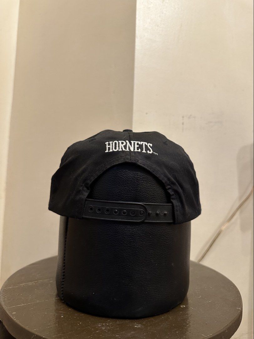 Vintage Charlotte Hornets NBA Cap (Category: Caps & Hats) located in Bacoor. Submitted by realbacktrack (Listing ID 1434888867, Image 3). Description: - Charlotte Hornets cap - Features Hornets logo on the front - "HORNETS" text on the back - Official NBA product by First Pick - Size: L - Material: 65% polyester, 35% cottonm *minor signs of usage.