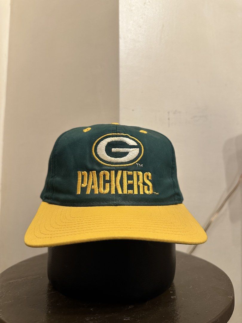 Vintage Green Bay Packers Cap (Category: Caps & Hats) located in Bacoor. Submitted by realbacktrack (Listing ID 1434888674, Image 1). Description: - Vintage Green Bay Packers cap - Features the iconic team logo - "PACKERS" embroidered below the logo - Classic green crown and yellow brim - Adjustable green strap for a perfect fit - White interior lining with team logo - Made by Eastport *signs if usage *stains inside (see pictures).