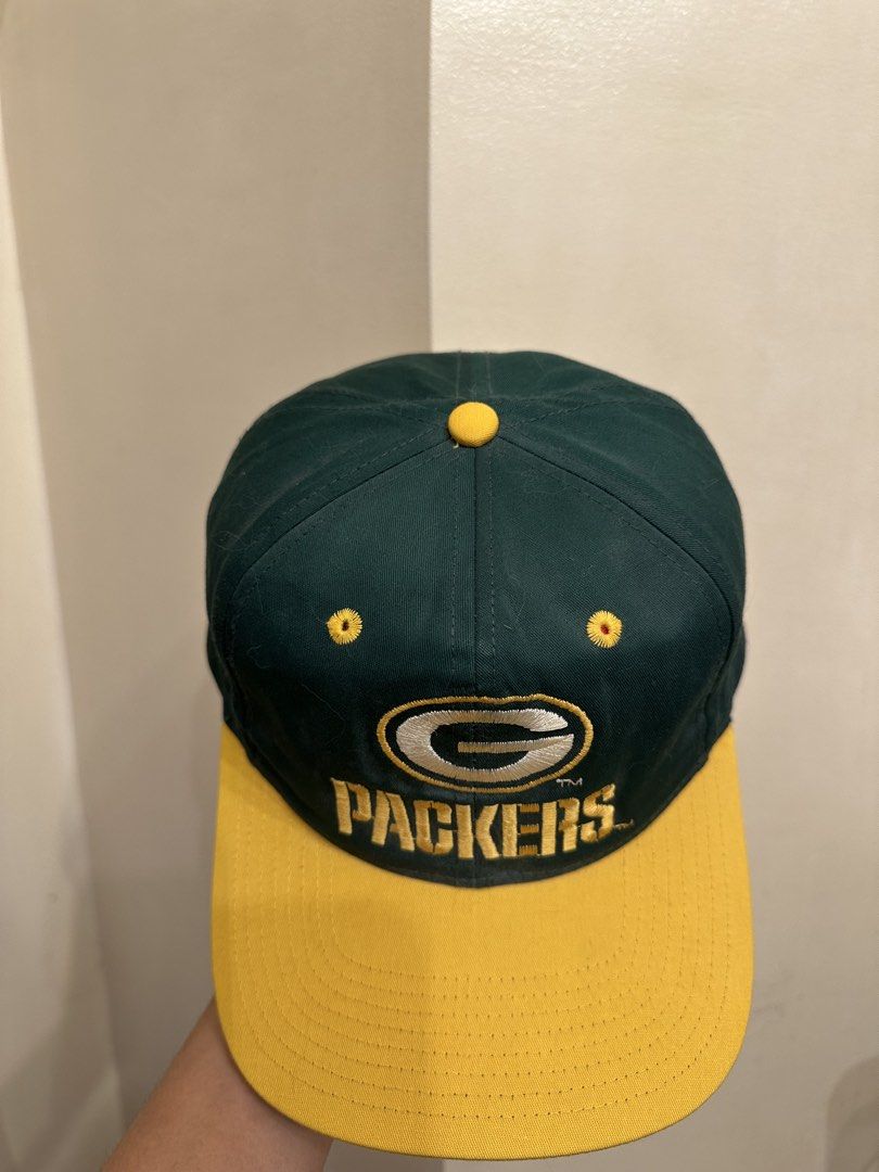 Vintage Green Bay Packers Cap (Category: Caps & Hats) located in Bacoor. Submitted by realbacktrack (Listing ID 1434888674, Image 3). Description: - Vintage Green Bay Packers cap - Features the iconic team logo - "PACKERS" embroidered below the logo - Classic green crown and yellow brim - Adjustable green strap for a perfect fit - White interior lining with team logo - Made by Eastport *signs if usage *stains inside (see pictures).