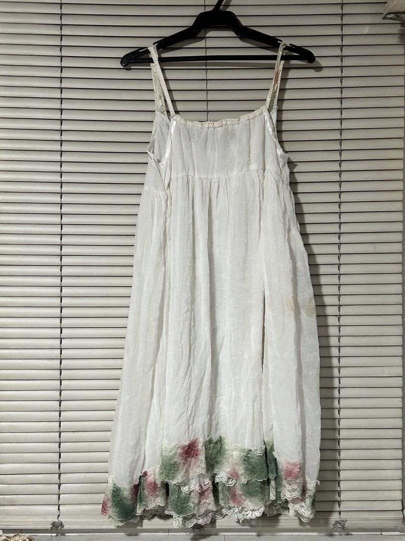 White Floral Tent Dress (Category: Dresses) located in Quezon City. Submitted by icaaa-sells (Listing ID 1434812082, Image 2). Description: Dimensions Bust - 15 in Length - 33 in Flaws Stain (in picture) RFS: Decluttering MOP: GCash/BDO/BPI Shipping fee care of buyer: Grab/Mr Speedy/LalaMove or GGX/J&T Seller location: 📍West Triangle, Quezon City - White dress with floral accents - Spaghetti straps - Flowing silhouette - Decorative trim on neckl