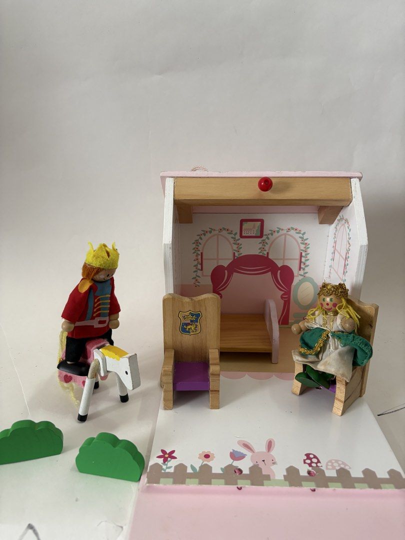 Wooden Dollhouse with Accessories (Category: Kids Toys) located in Quezon City. Submitted by tilllabloo (Listing ID 1434946820, Image 2). Description: - Cute pink and white wooden dollhouse - Comes with miniature furniture (chairs, bed) - Includes wooden prince and princess dolls - Features a toy horse - Has a slot on the roof (piggy bank function).