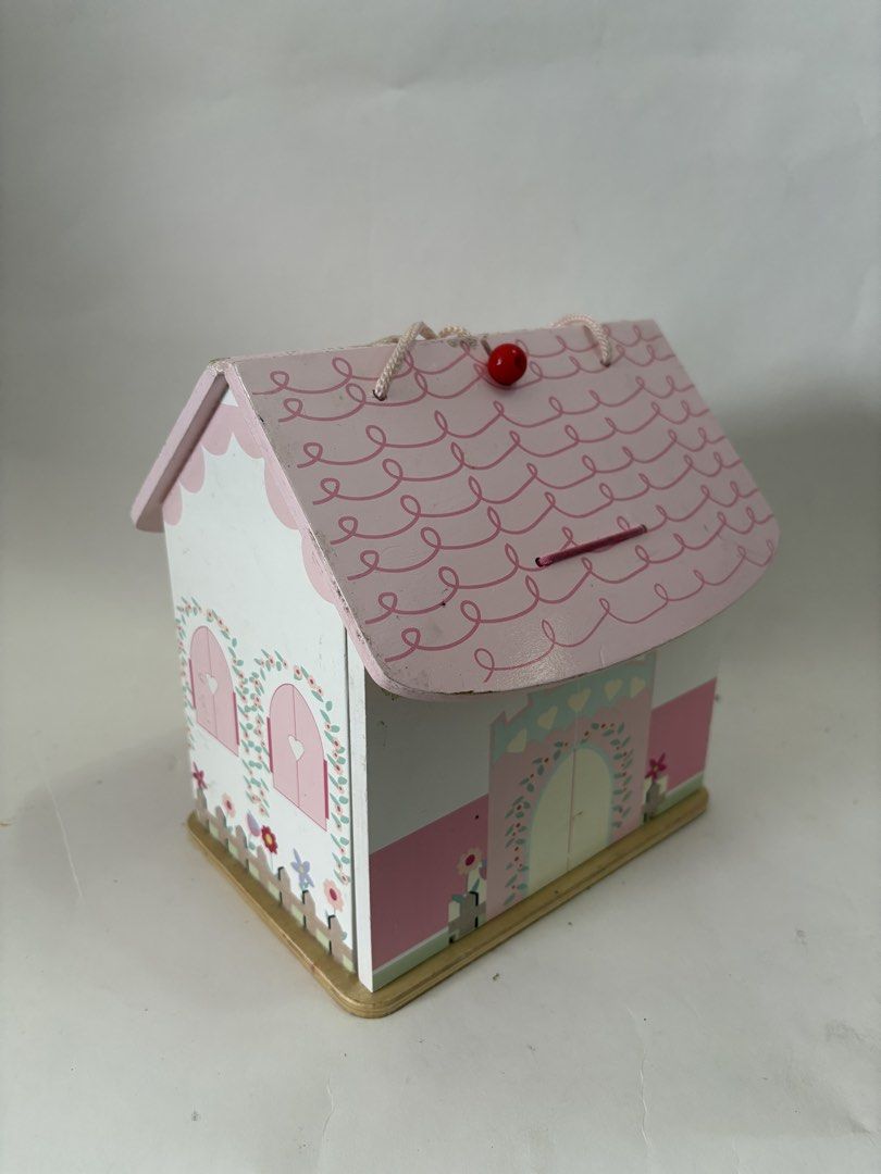 Wooden Dollhouse with Accessories (Category: Kids Toys) located in Quezon City. Submitted by tilllabloo (Listing ID 1434946820, Image 1). Description: - Cute pink and white wooden dollhouse - Comes with miniature furniture (chairs, bed) - Includes wooden prince and princess dolls - Features a toy horse - Has a slot on the roof (piggy bank function).