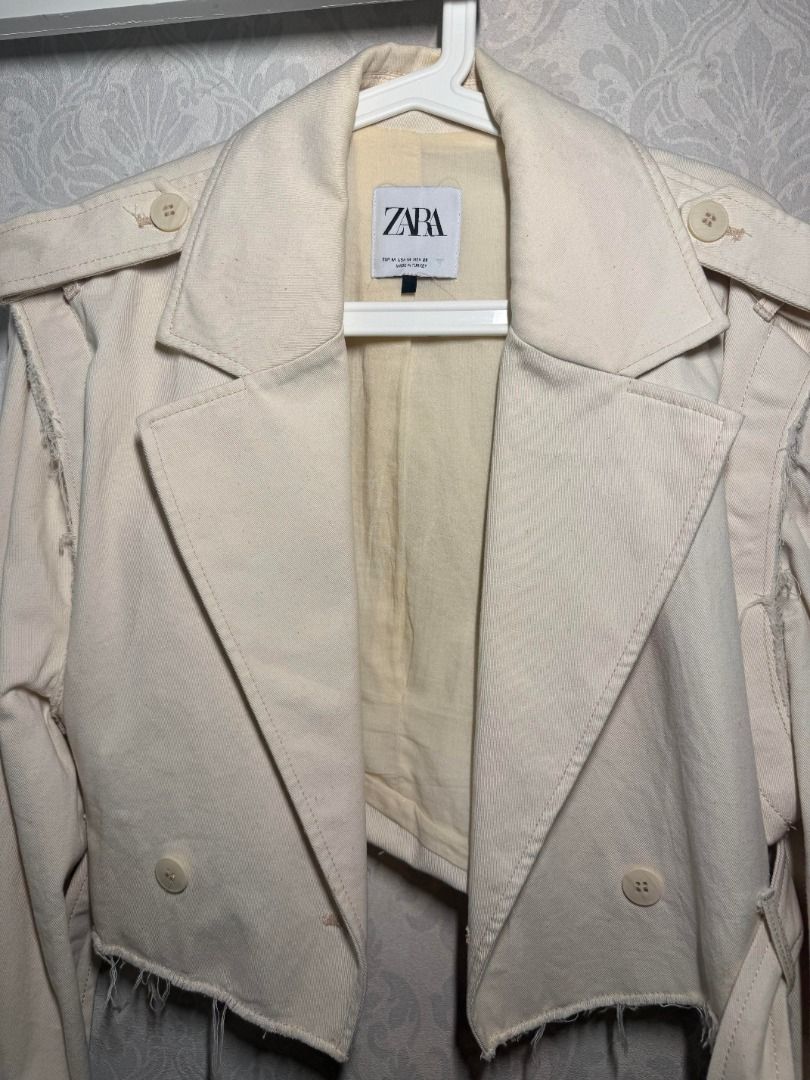 Zara Cropped Jacket with Detachable Sleeves (Category: Coats, Jackets and Outerwear) located in Muntinlupa City. Submitted by clauisstuff (Listing ID 1434916222, Image 3). Description: Zara cream cropped jacket with detachable sleeves - Has buttons on sleeves - Includes a belt - Decorative shoulder details - Raw, frayed hemline RFS: Decluttering MOP: BDO/BPI/GoTyme LOC: Muntinlupa/Taguig.