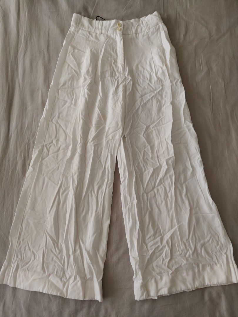 Zara White Wide Leg Pants (Category: Other Bottoms) located in Makati City. Submitted by shopsaleph (Listing ID 1434853114, Image 1). Description: - Zara white wide-leg pants -hem length adjusted to fit petite height ,but temporary hem seams can be removed (see photos) - Button and zipper closure - High-waisted - Two front pockets - Made of lightweight fabric - Perfect for warm weather - Can be styled casually or dressed up #zara #pants #womens #