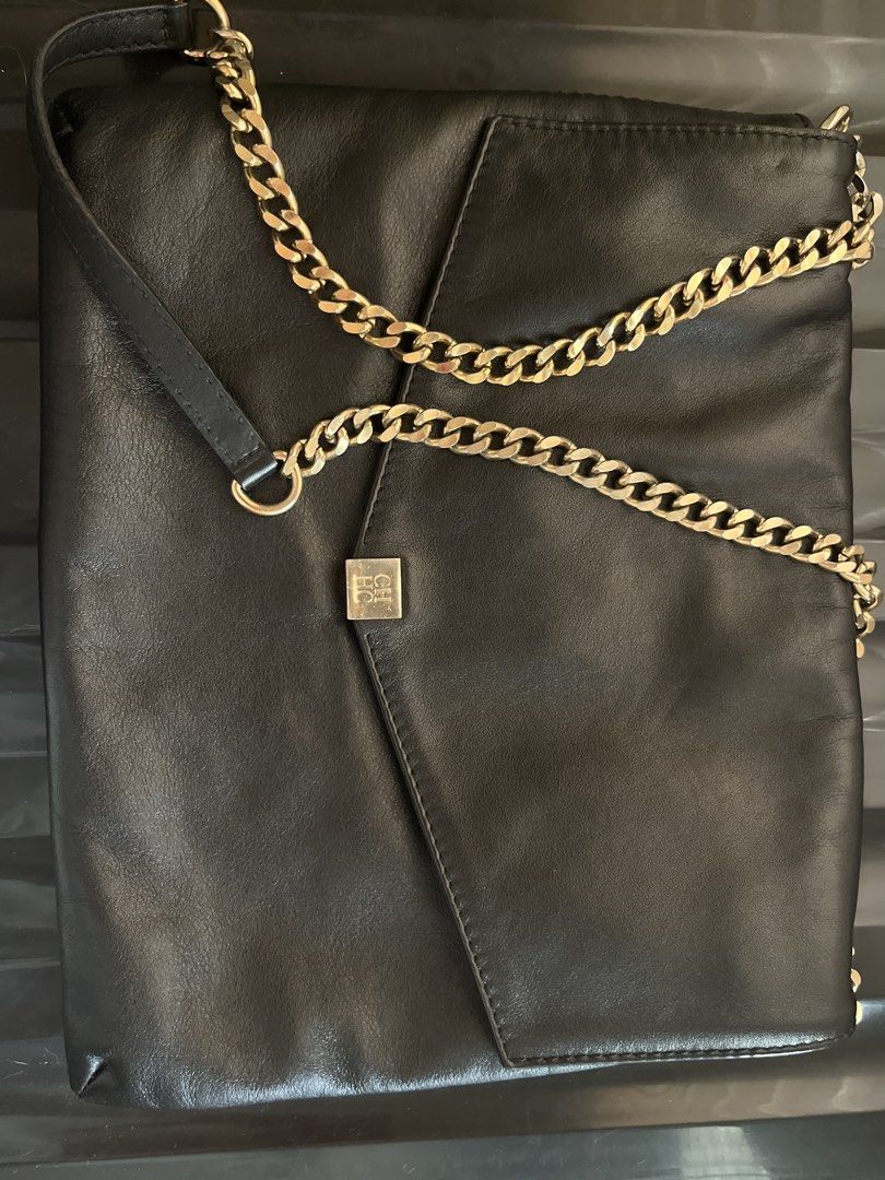 Authentic Carolina Herrera handbag with Gold Chain strap (Category: Luxury Bags & Wallets) located in Davao. Submitted by marsad (Listing ID 1435003095, Image 2). Description: - Decluttering Barely used Black leather handbag - Gold chain strap - Square logo on front flap - Interior zipper pocket - Fold-over design - Adjustable chain strap (shoulder or crossbody) - Made with high-quality leather.