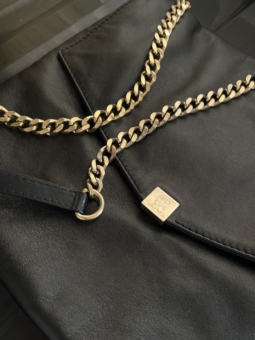 Authentic Carolina Herrera handbag with Gold Chain strap (Category: Luxury Bags & Wallets) located in Davao. Submitted by marsad (Listing ID 1435003095, Image 3). Description: - Decluttering Barely used Black leather handbag - Gold chain strap - Square logo on front flap - Interior zipper pocket - Fold-over design - Adjustable chain strap (shoulder or crossbody) - Made with high-quality leather.