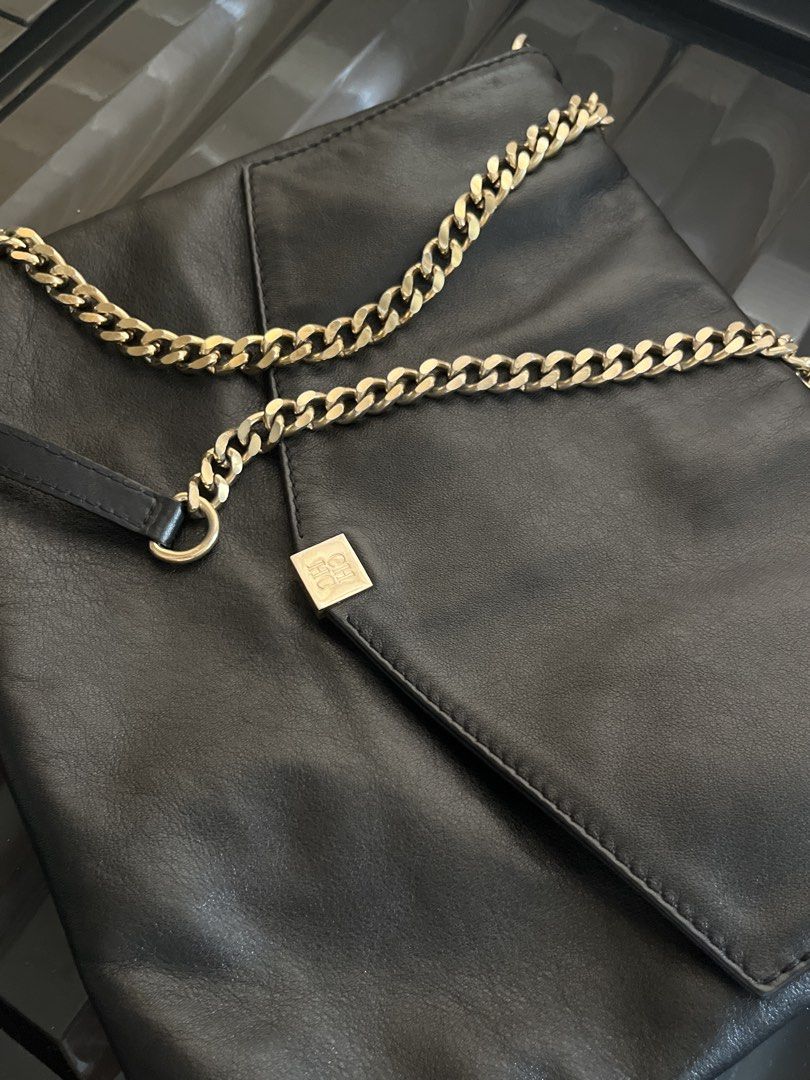 Authentic Carolina Herrera handbag with Gold Chain strap (Category: Luxury Bags & Wallets) located in Davao. Submitted by marsad (Listing ID 1435003095, Image 1). Description: - Decluttering Barely used Black leather handbag - Gold chain strap - Square logo on front flap - Interior zipper pocket - Fold-over design - Adjustable chain strap (shoulder or crossbody) - Made with high-quality leather.