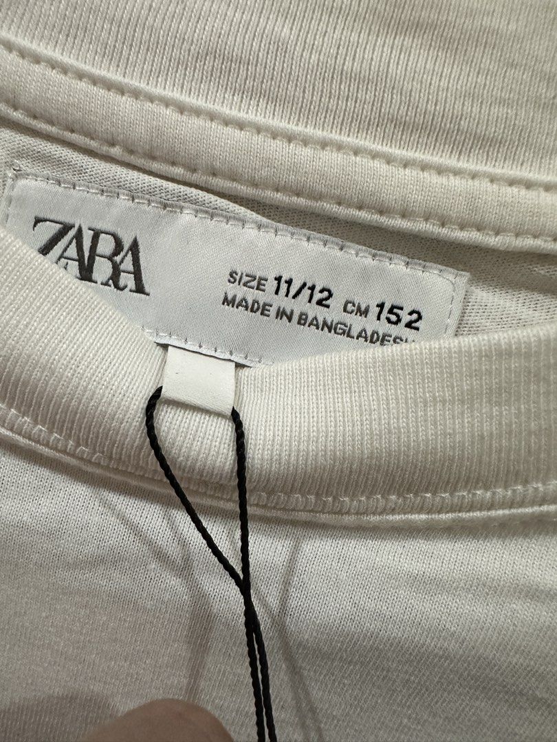 Authentic Zara Groovy Gardens Tee Size 11/12 (Category: Babies & Kids Fashion) located in Mandaue City. Submitted by decluttermama88 (Listing ID 1435072809, Image 2). Description: ZARA Kids “Groovy Garden” Graphic Tee – White – Size 11/12 (152cm) Cute retro-style graphic tee from ZARA Kids Color: White Size: 11/12 years (152 cm) Fit: Relaxed / slightly oversized for kids (can fit petite adults XS) Condition: Excellent / Like New - No stains, hole