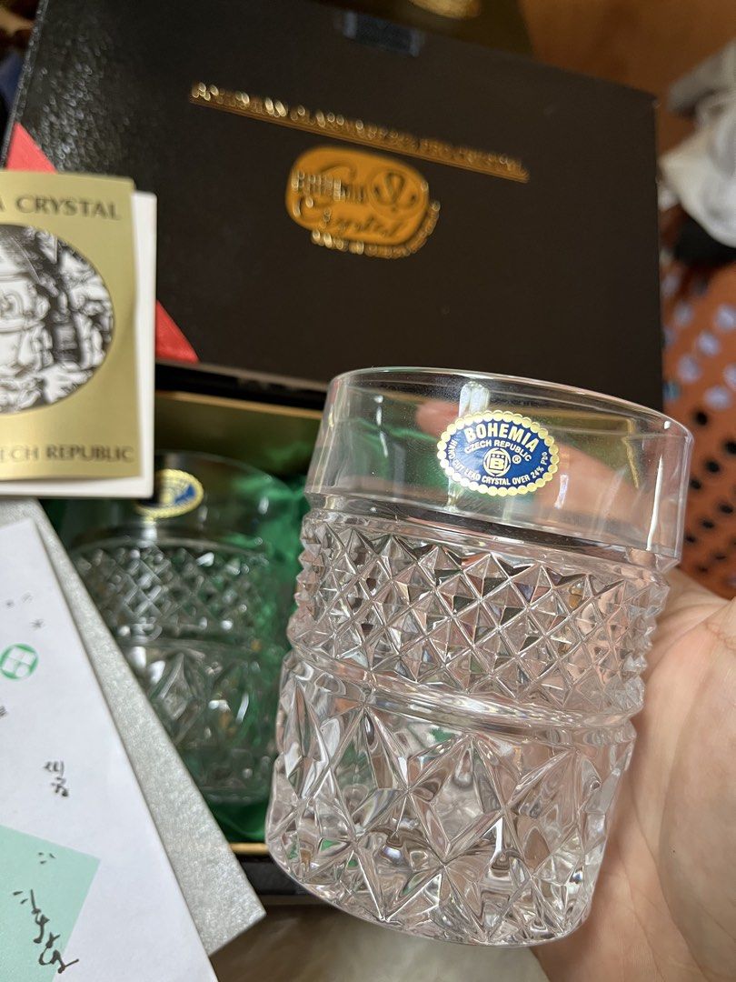 Bohemia Crystal Glassware Set (Category: Other Kitchenware & Tableware) located in Tandag. Submitted by maryarlale42144 (Listing ID 1435024578, Image 3). Description: - Bohemia Crystal glassware set - Made in Czech Republic - Includes two boxes - Each box contains two crystal glasses - Diamond-cut design - Black boxes with gold accents - Bohemia Crystal logo on boxes - Each glass has a blue sticker.