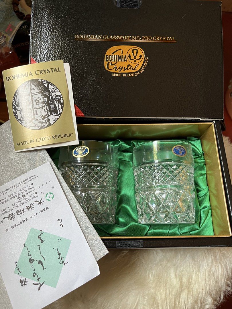 Bohemia Crystal Glassware Set (Category: Other Kitchenware & Tableware) located in Tandag. Submitted by maryarlale42144 (Listing ID 1435024578, Image 2). Description: - Bohemia Crystal glassware set - Made in Czech Republic - Includes two boxes - Each box contains two crystal glasses - Diamond-cut design - Black boxes with gold accents - Bohemia Crystal logo on boxes - Each glass has a blue sticker.