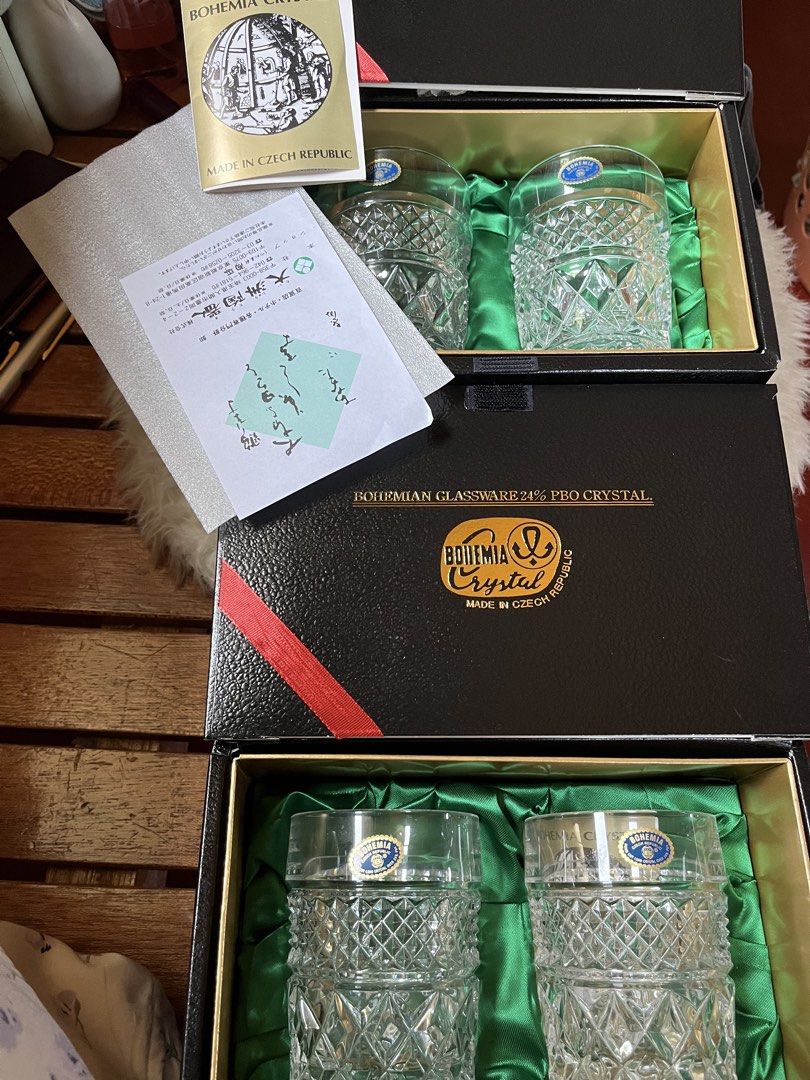 Bohemia Crystal Glassware Set (Category: Other Kitchenware & Tableware) located in Tandag. Submitted by maryarlale42144 (Listing ID 1435024578, Image 1). Description: - Bohemia Crystal glassware set - Made in Czech Republic - Includes two boxes - Each box contains two crystal glasses - Diamond-cut design - Black boxes with gold accents - Bohemia Crystal logo on boxes - Each glass has a blue sticker.