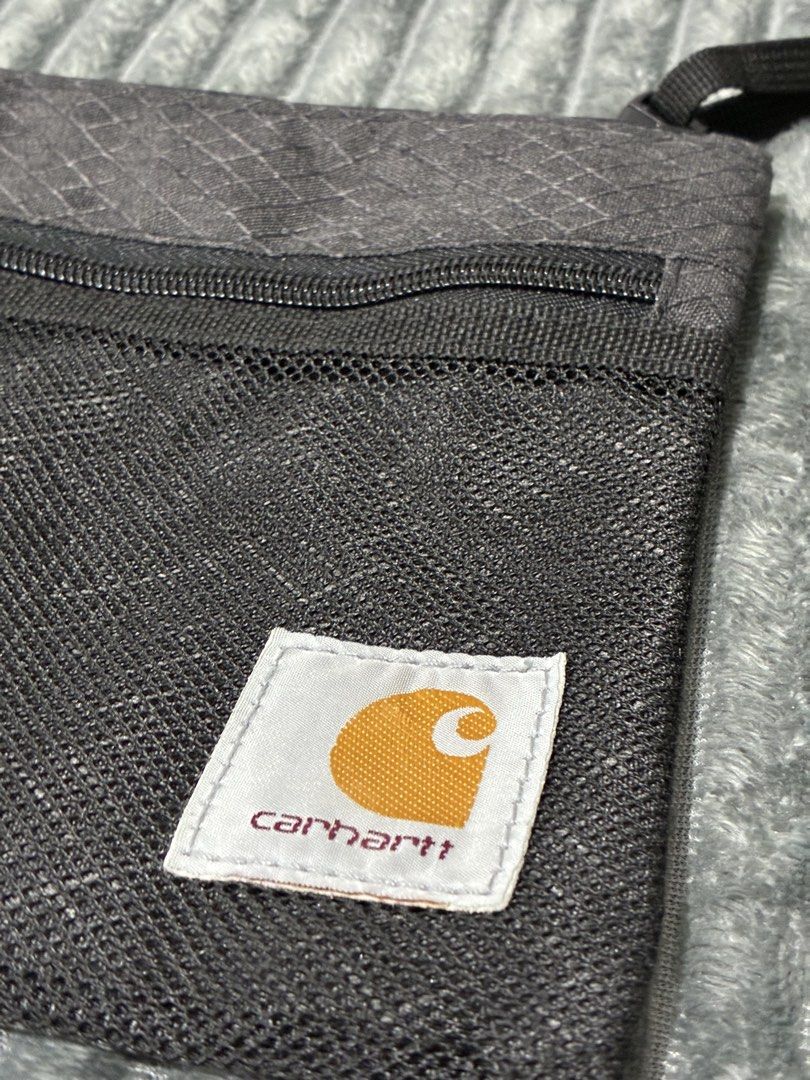 Carhartt Sprey Strap Sling Bag Black (Category: Sling Bags) located in Tarlac. Submitted by ayla.shop (Listing ID 1435082238, Image 2). Description: - Carhartt Crossbody Bag - Main compartment with zipper - Front pocket with zipper - Adjustable shoulder strap - Unique diamond pattern - Features the Carhartt logo - Condition: 9.5/10 Almost Brandnew Meet up or plus shipping via LBC Express (COD/COP/Gcash/BankTransfer).