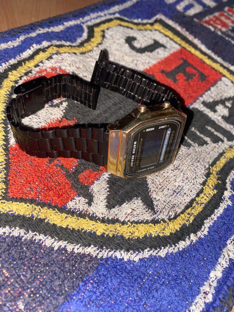 Vintage Casio Digital Watch (Category: Men's Watches) located in San Jose del Monte. Submitted by dripfromthrift2 (Listing ID 1435168174, Image 3). Description: - Casio digital watch - Black metal strap - Gold-colored case - Alarm function - Chronograph (chrono) function - Illuminator function - Displays time and date - Water-resistant - Casio logo and model information on the back.
