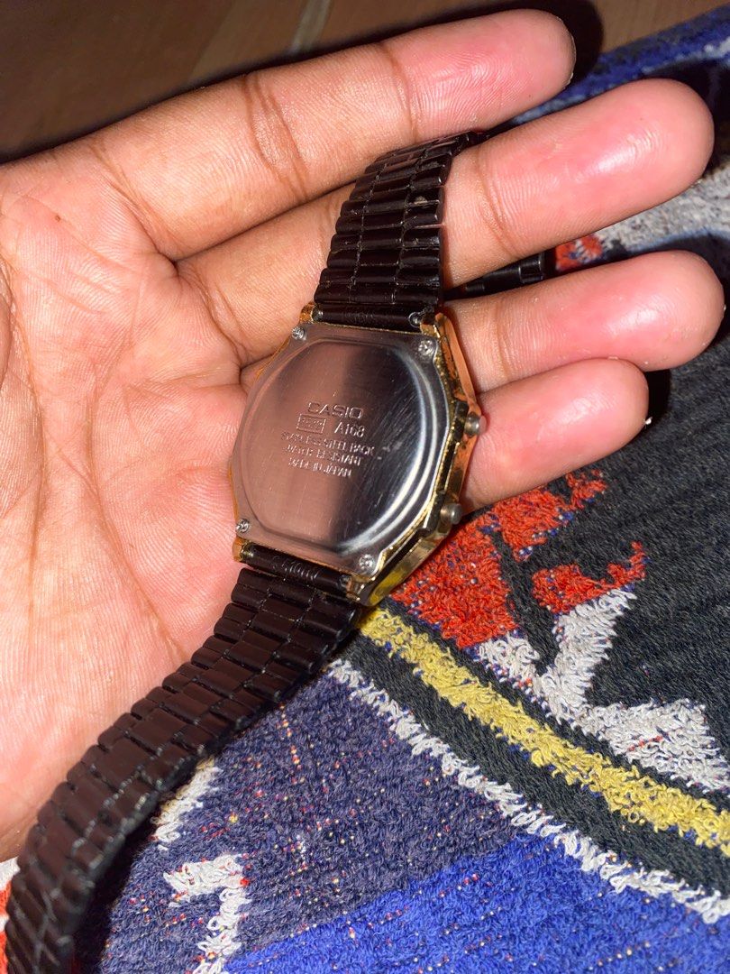 Vintage Casio Digital Watch (Category: Men's Watches) located in San Jose del Monte. Submitted by dripfromthrift2 (Listing ID 1435168174, Image 2). Description: - Casio digital watch - Black metal strap - Gold-colored case - Alarm function - Chronograph (chrono) function - Illuminator function - Displays time and date - Water-resistant - Casio logo and model information on the back.