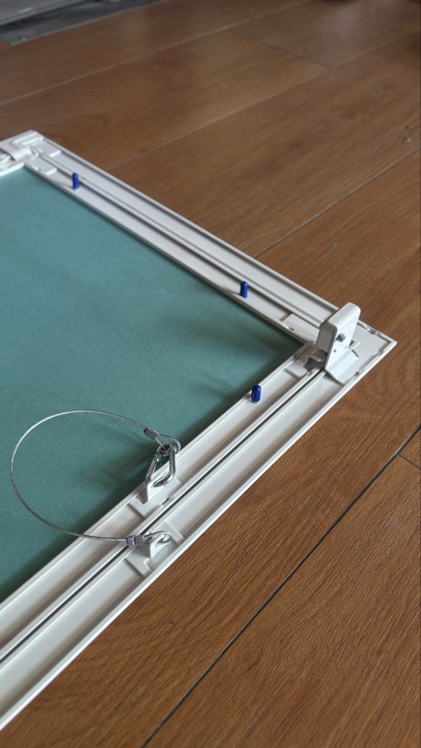 Ceiling Access Panel / Manhole (Category: Construction & Building Materials) located in Pasig City. Submitted by shiroshonen (Listing ID 1435071416, Image 3). Description: - White access panel - Teal-colored interior - Hinged design with metal wire support - Rectangular shape - Made of sturdy material - Features blue clips for secure closure - Ideal for covering wall or ceiling openings.