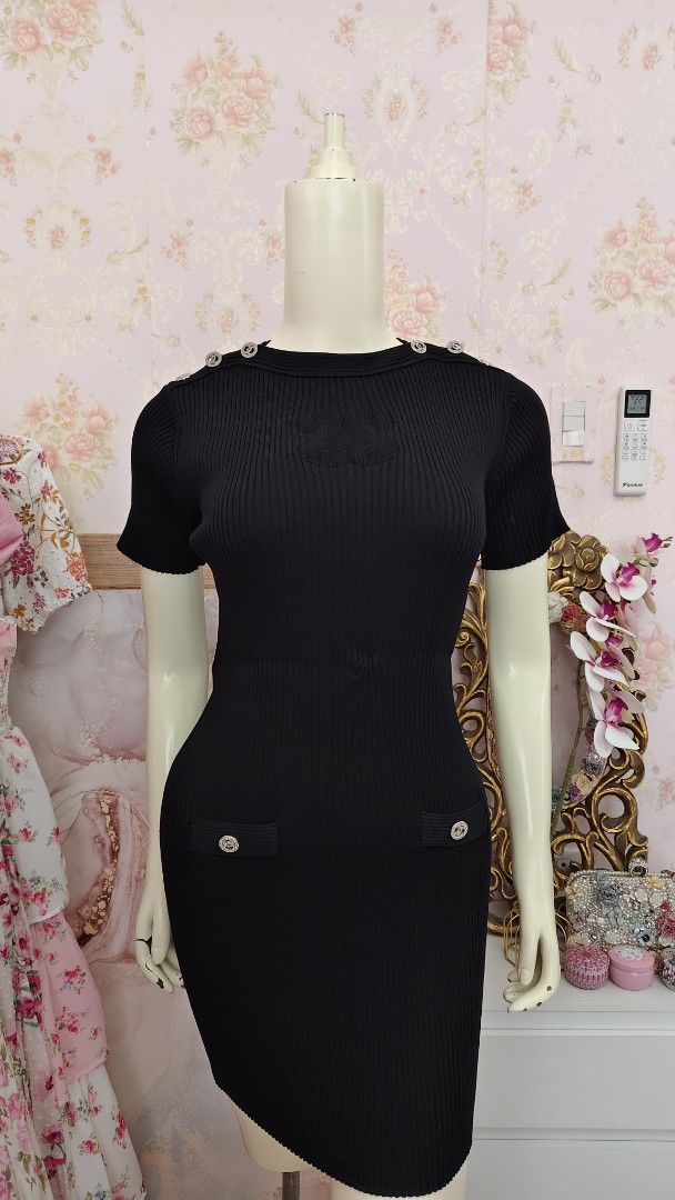 Chanel Black Knit Dress (Category: Luxury Apparel) located in Pagudpud. Submitted by altheacee063978 (Listing ID 1435123466, Image 1). Description: -fits s-m - Black knit dress - Short sleeves - Fitted silhouette - Decorative buttons on shoulders and pockets - Ribbed texture - Sophisticated design.