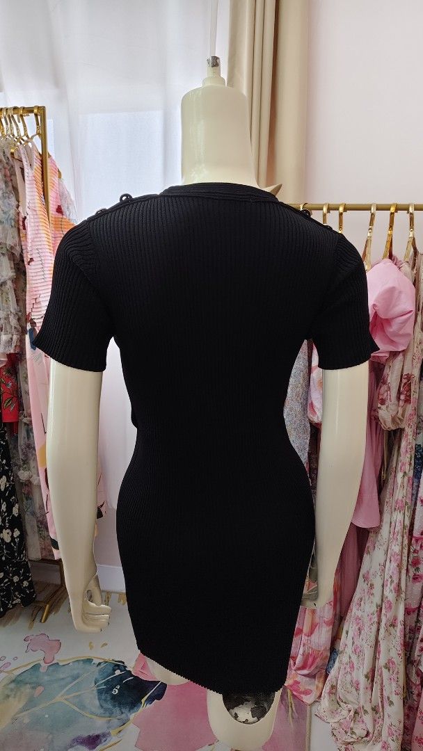 Chanel Black Knit Dress (Category: Luxury Apparel) located in Pagudpud. Submitted by altheacee063978 (Listing ID 1435123466, Image 3). Description: -fits s-m - Black knit dress - Short sleeves - Fitted silhouette - Decorative buttons on shoulders and pockets - Ribbed texture - Sophisticated design.