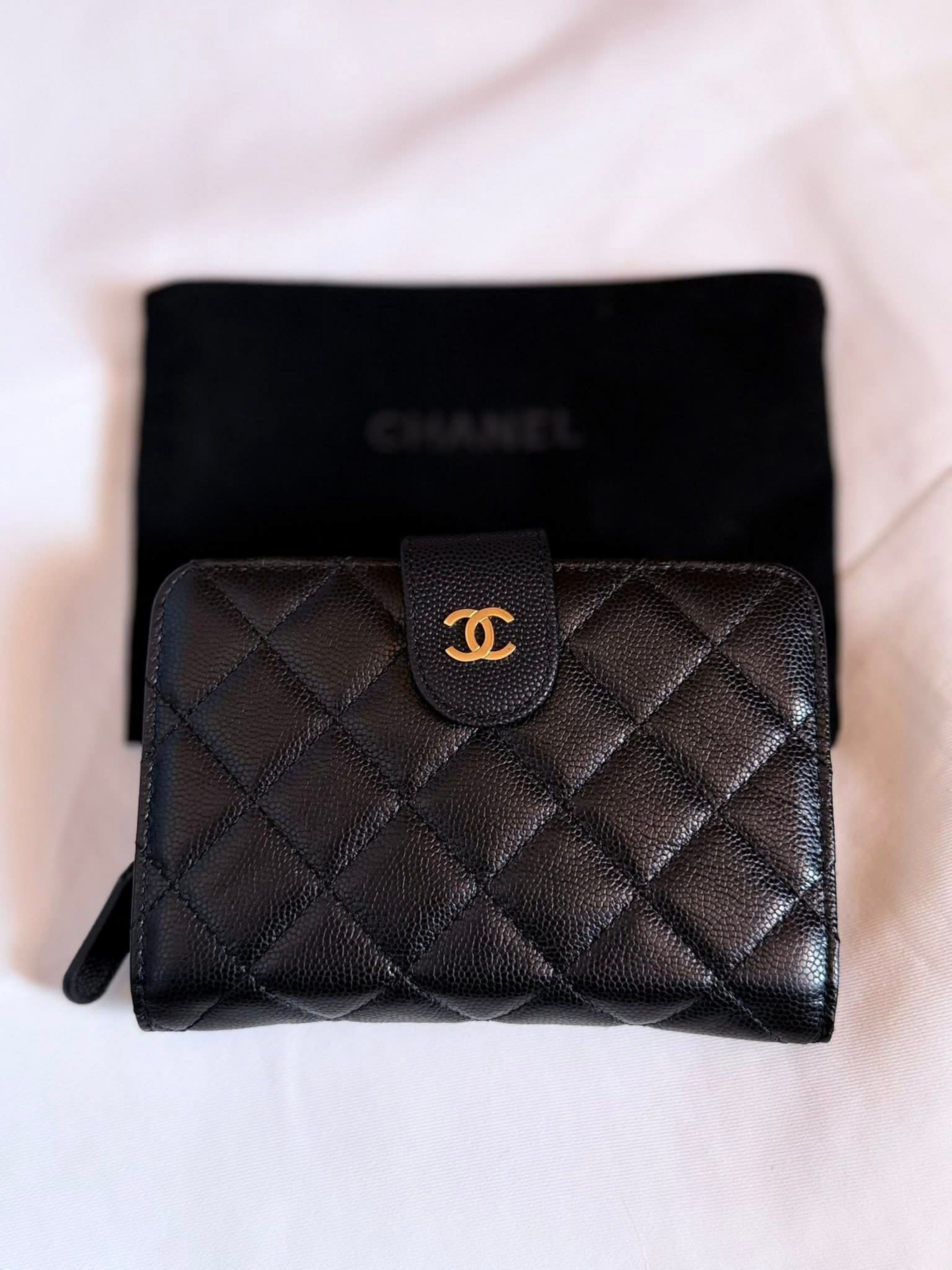 Chanel Quilted Caviar Leather Wallet (NGA) (Category: Luxury Bags & Wallets) located in Manila. Submitted by avellene (Listing ID 1435167622, Image 1). Description: - Black quilted caviar leather - Snap closure - Burgundy leather lining - Multiple card slots - Zippered coin compartment - Includes Chanel dust bag NGA.