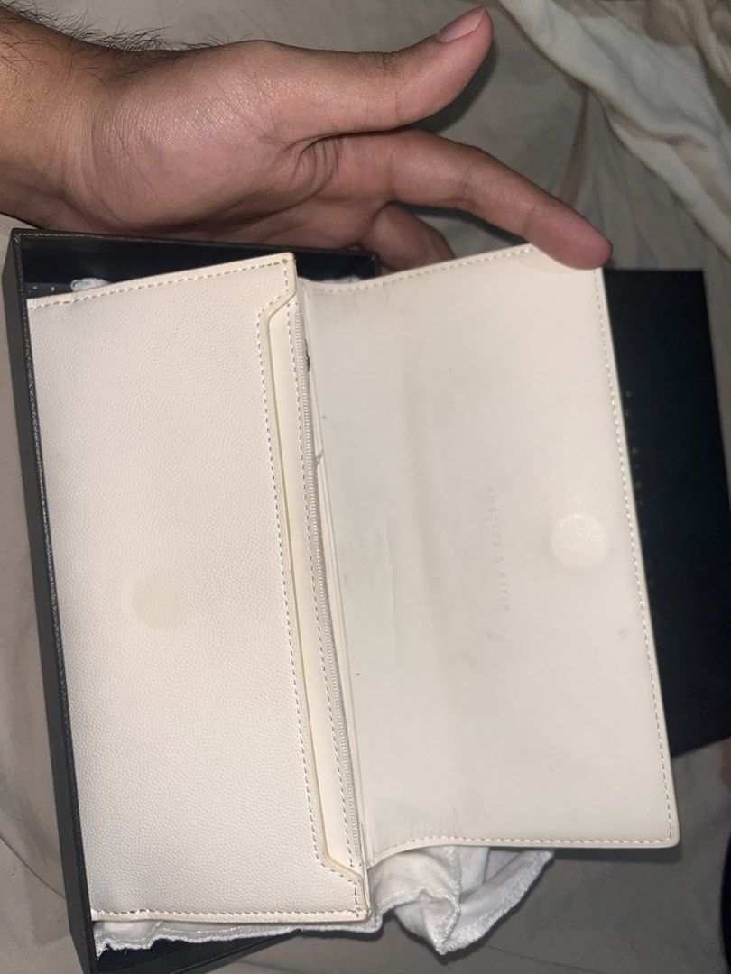 Charles & Keith Wallet (Category: Wallets & Card holders) located in Manila. Submitted by sethsethsethseth (Listing ID 1435120220, Image 3). Description: - Charles & Keith cream wallet - Rectangular shape - Silver-colored clasp - Multiple compartments - Includes a zippered pocket - Comes with original box and dust bag.