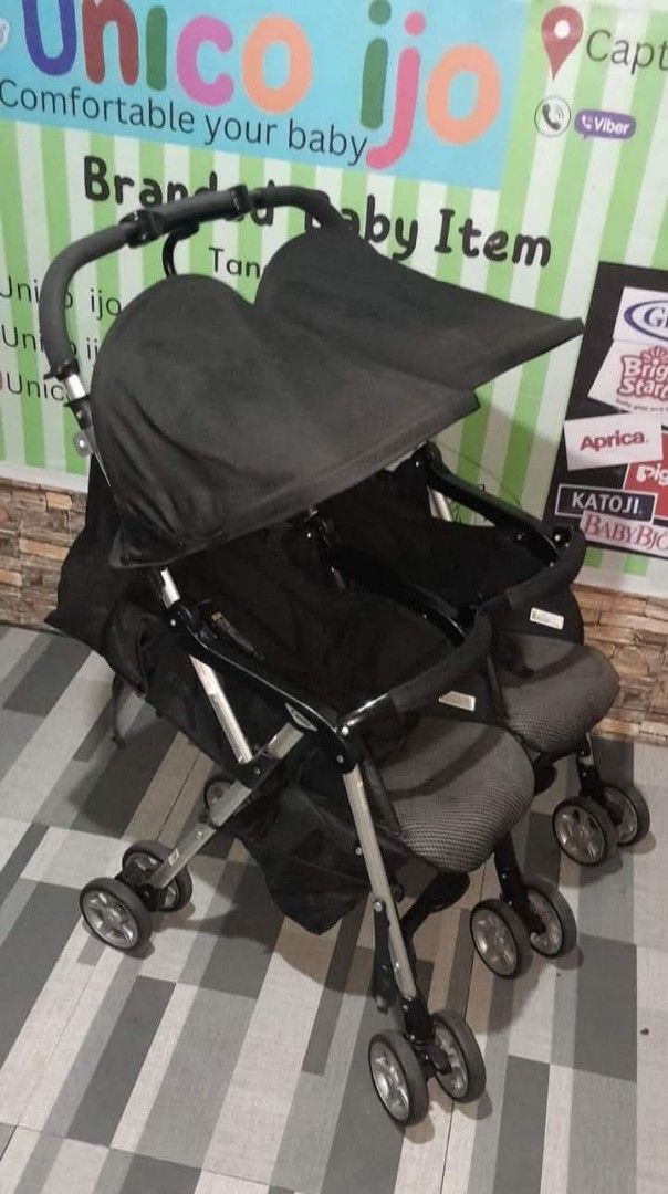 Double Stroller (Category: Strollers) located in Caloocan City. Submitted by Unicoijo02 (Listing ID 1435062669, Image 1). Description: - Black double stroller - Two seats with canopies - Foldable design - Multiple wheels for stability - Curved handle for comfortable pushing.