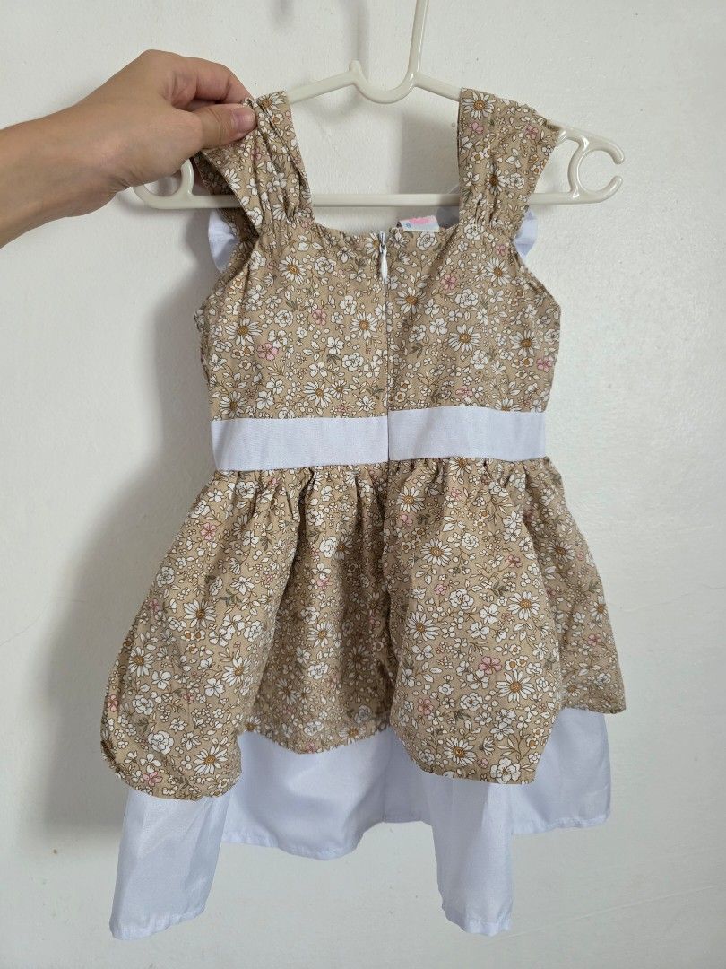 Floral Dress with Bows (Category: Babies & Kids Fashion) located in Taguig. Submitted by jeaniper (Listing ID 1435110806, Image 2). Description: - Adorable floral print dress - Square neckline - Charming bow accents on straps - White waistband - Layered skirt with white underlay - Approximately 18 inches in length - Convenient zipper closure at the back.