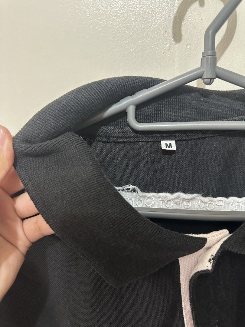 GHD Black Polo Shirt (Category: Tshirts & Polo Shirts ) located in Caloocan City. Submitted by _chinkypotato16 (Listing ID 1435026777, Image 3). Description: Brand: N/A - Black polo shirt, size M - White accents on sleeves - GHD logo on front - "The Power of Commitment" printed on back - Classic polo collar - Buttoned placket 💳 Mode of Payment: 💙 Gcash 🛵 Mode of Delivery: Same Day - Grab Express/ Lalamove .