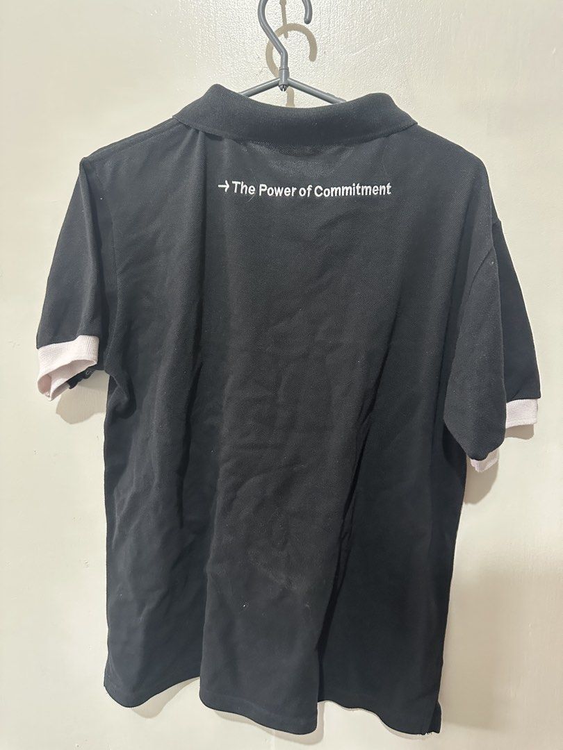 GHD Black Polo Shirt (Category: Tshirts & Polo Shirts ) located in Caloocan City. Submitted by _chinkypotato16 (Listing ID 1435026777, Image 2). Description: Brand: N/A - Black polo shirt, size M - White accents on sleeves - GHD logo on front - "The Power of Commitment" printed on back - Classic polo collar - Buttoned placket 💳 Mode of Payment: 💙 Gcash 🛵 Mode of Delivery: Same Day - Grab Express/ Lalamove .
