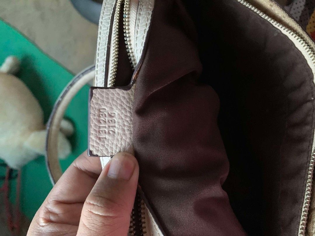 Gucci GG Canvas Tote Bag (Category: Luxury Bags & Wallets) located in Tarlac. Submitted by jaesii00 (Listing ID 1435141319, Image 3). Description: - Gucci tote bag - Iconic GG canvas pattern - Beige exterior with white leather trim - Zipper closure - Spacious interior with brown lining - Includes leather tag with Gucci logo and "Made in Italy" - Serial number tag -issue scratch sa ilalim.