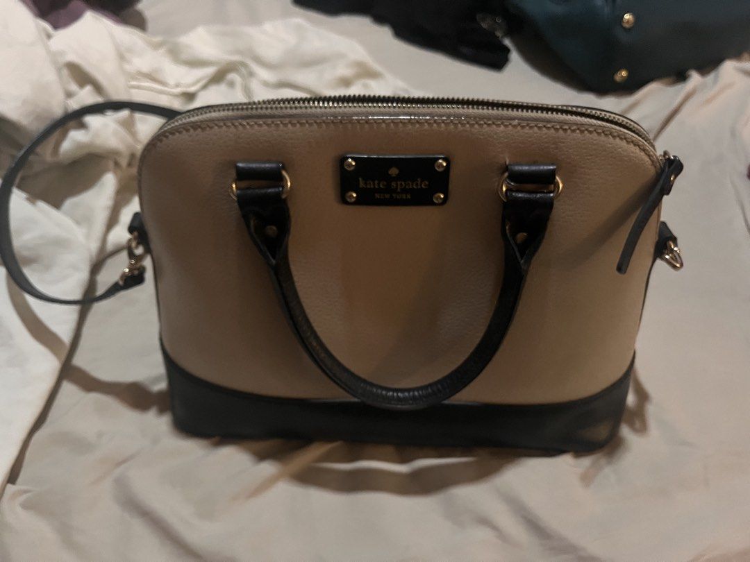 Kate Spade Dome Satchel Handbag (Category: Luxury Bags & Wallets) located in Manila. Submitted by sethsethsethseth (Listing ID 1435119946, Image 1). Description: - Kate Spade dome satchel - Color: Beige and black - Features: - Top handle - Detachable shoulder strap - Zip closure - Multiple interior pockets - Gold-tone hardware - Interior lined with patterned fabric - Kate Spade logo on front BUYING MORE THAN 1 ITEM WILL BE OFFERED DISCOUNTS..