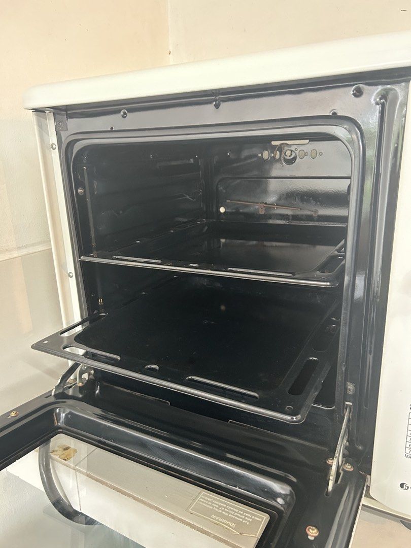 La Germania SL 100 TD Oven (Category: Ovens & Toasters) located in Makati City. Submitted by declutter__queen (Listing ID 1435045942, Image 2). Description: - La Germania SL 100 TD gas oven. - White exterior with a black interior. - Features a glass door. - Includes multiple racks. - Equipped with a temperature control knob. - Designed for gas (LPG tank connection via included hose)..