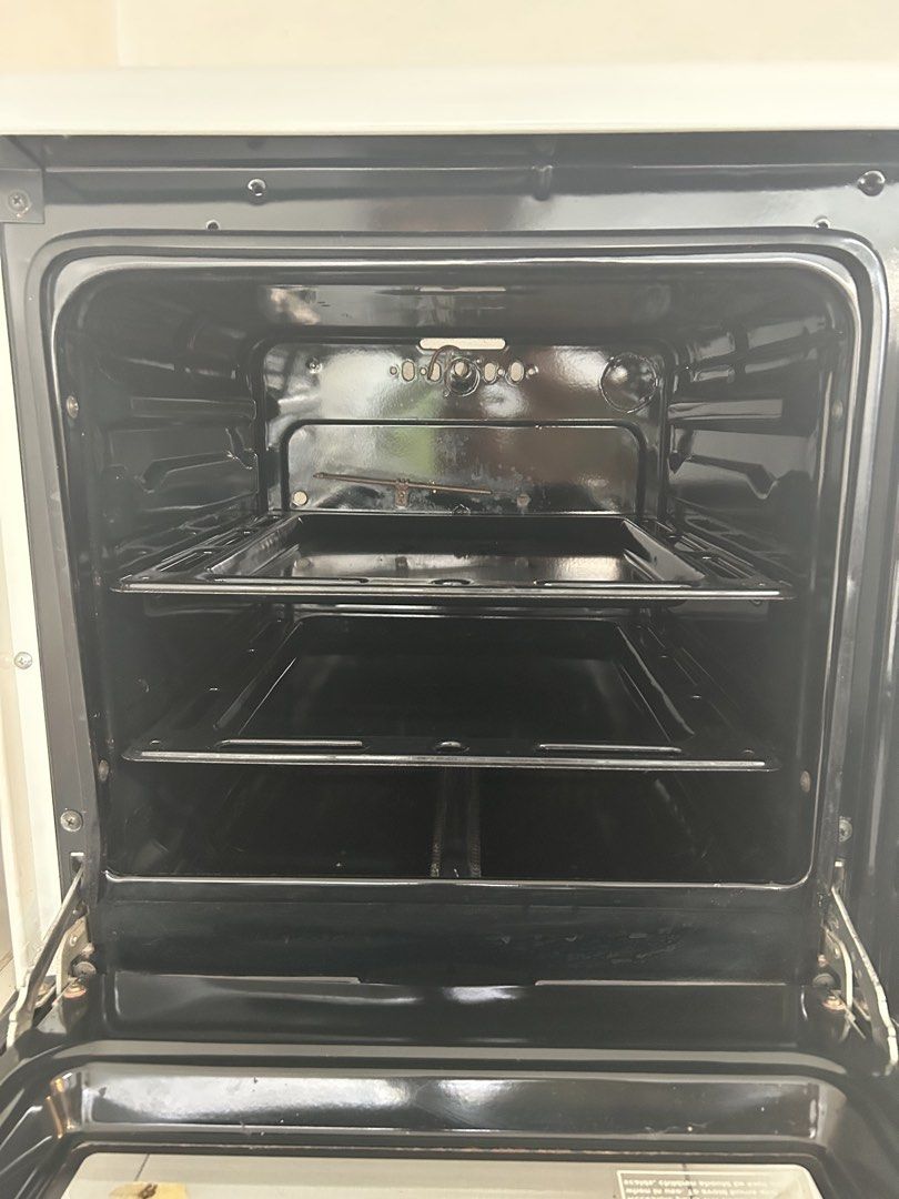 La Germania SL 100 TD Oven (Category: Ovens & Toasters) located in Makati City. Submitted by declutter__queen (Listing ID 1435045942, Image 3). Description: - La Germania SL 100 TD gas oven. - White exterior with a black interior. - Features a glass door. - Includes multiple racks. - Equipped with a temperature control knob. - Designed for gas (LPG tank connection via included hose)..