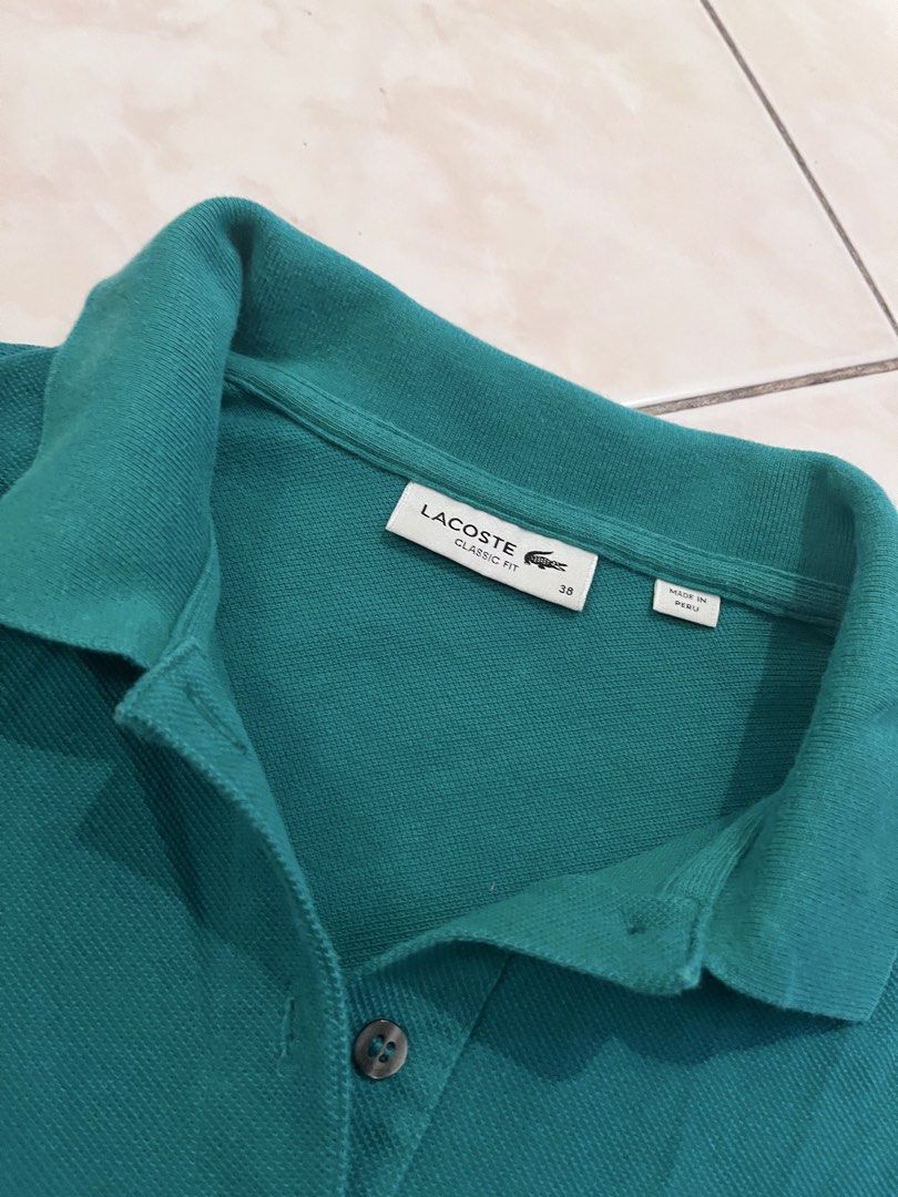 Lacoste Classic Fit Polo Shirt (Category: Shirts) located in Quezon City. Submitted by markupapparel (Listing ID 1435009910, Image 1). Description: - Authentic Lacoste polo shirt - Teal green color - Classic fit - Size 38 - Button-down collar - Made in Peru - Comfortable for everyday wear.