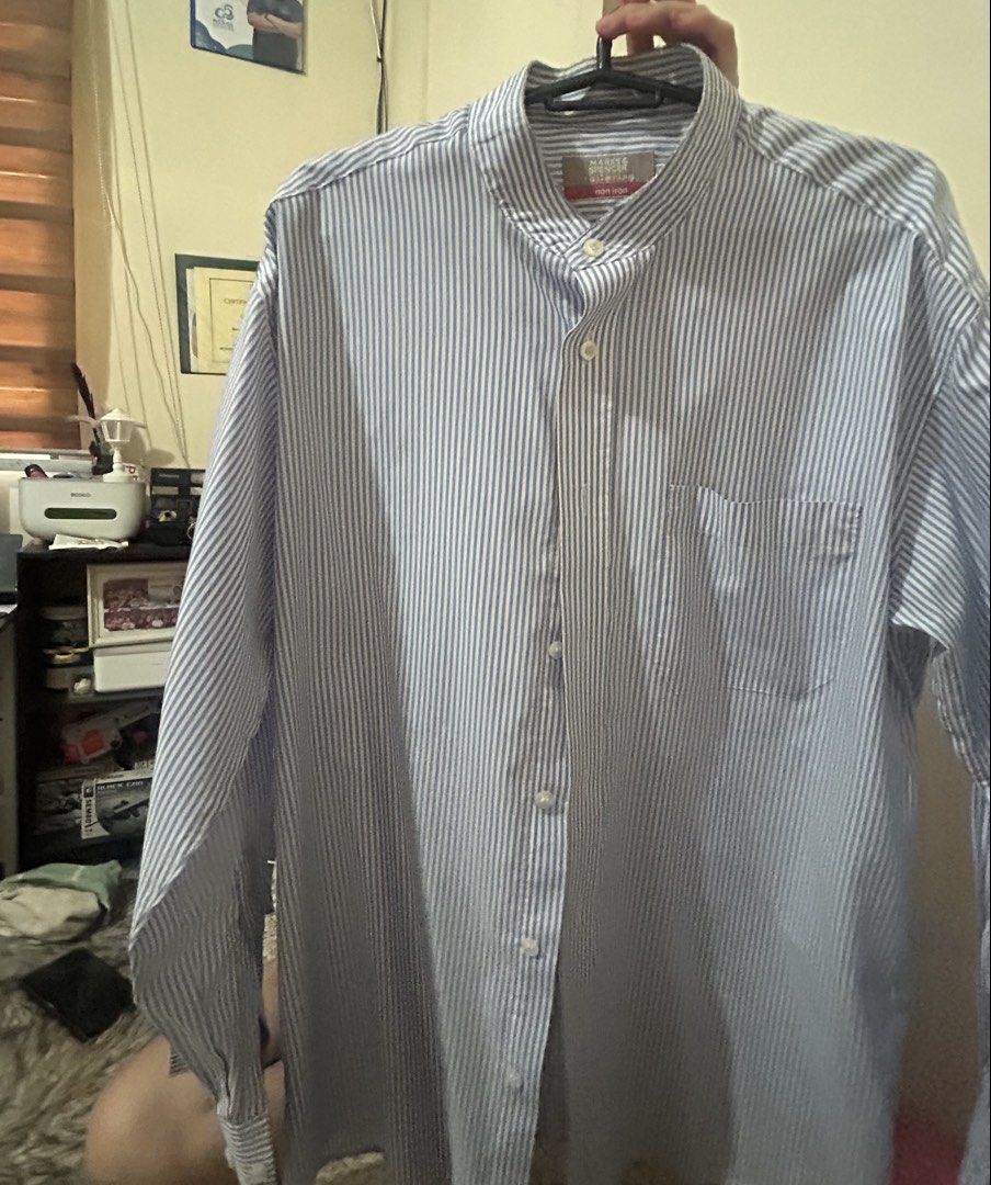 Marks & Spencer Striped Long Sleeve Shirt (Category: Tshirts & Polo Shirts ) located in Quezon City. Submitted by raki17 (Listing ID 1435008416, Image 2). Description: - Marks & Spencer long sleeve shirt - Blue and white stripes - Mandarin collar - Single chest pocket - Buttoned cuffs - Size: Large - Lightweight fabric - Suitable for casual or semi-formal wear.