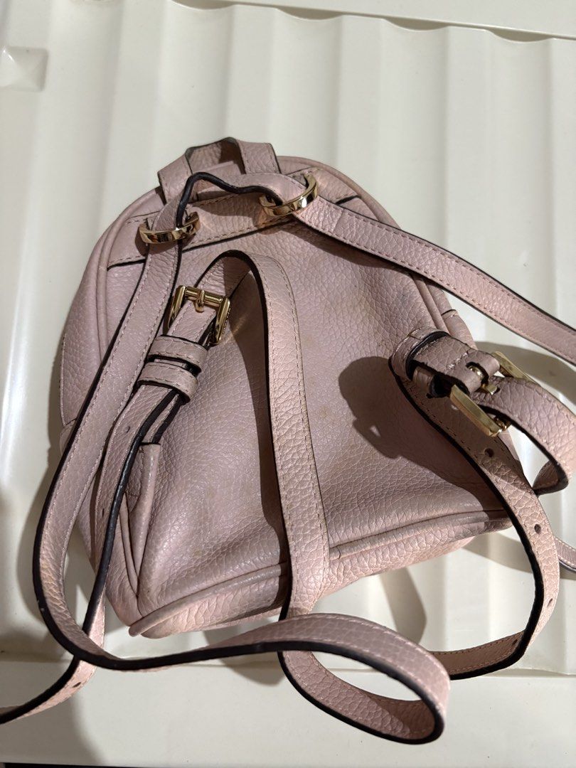 Authentic Michael Kors Mini Backpack (Category: Backpacks) located in Talavera. Submitted by charmaine.delima (Listing ID 1435052623, Image 3). Description: - Michael Kors mini backpack - Blush pink color - Gold-tone hardware - Top handle and adjustable straps - Sling bag/ Backpack - Main compartment and front pocket - With visible minimal stain .