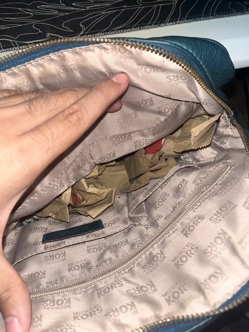 Michael Kors Satchel Handbag (Category: Luxury Bags & Wallets) located in Manila. Submitted by sethsethsethseth (Listing ID 1435119761, Image 3). Description: - Michael Kors satchel handbag - Top handle design - Gold-toned hardware - Branded interior lining - Multiple interior compartments - Zip closure - Includes logo charm.