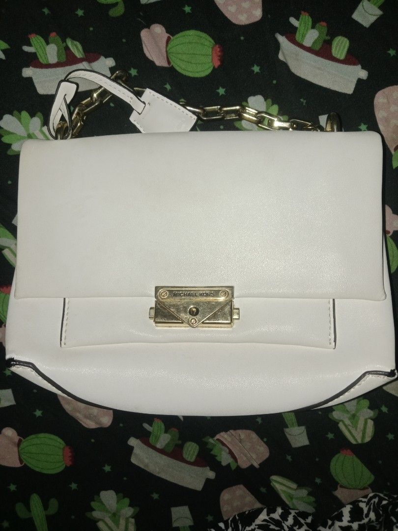 Michael Kors White Shoulder Bag (Category: Luxury Bags & Wallets) located in Zamboanga. Submitted by swiftfish-082e (Listing ID 1435037870, Image 1). Description: - Michael Kors shoulder bag - White leather exterior - Elegant gold-tone chain strap - Secure flap closure with gold-tone MK logo lock - Structured, classic design - Single main compartment - Includes a small handle.