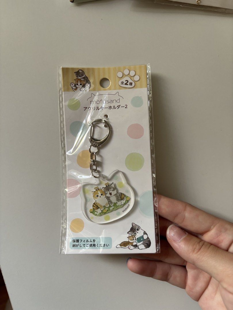 Mofusand Cat Keychain & Card Holder (Category: Toys & Games) located in Singapore. Submitted by crochetengg (Listing ID 1435061729, Image 2). Description: - Brand new, in original packaging - Mofusand card holder: $5 - Mofusand acrylic keychain: $2 - Both for $6 .