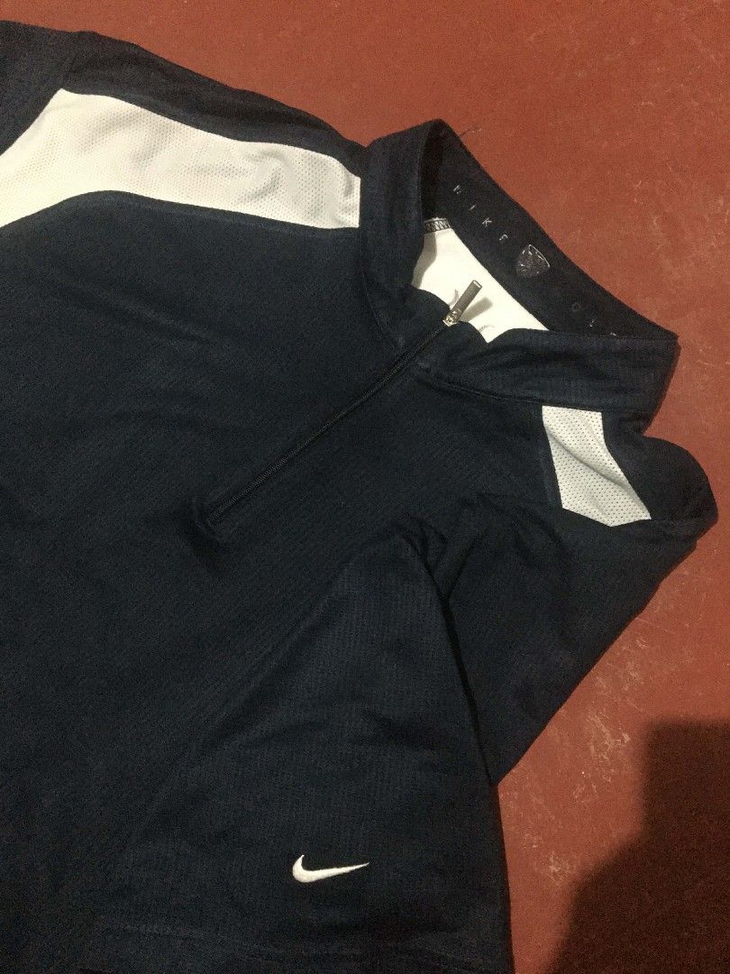 Nike Golf Short Sleeve Shirt (Category: Tshirts & Polo Shirts ) located in Manila. Submitted by llicht (Listing ID 1435114366, Image 2). Description: - Nike golf shirt in navy blue with white accents - Half-zip closure - Nike logo on the chest - Short sleeves - Breathable design - Made of polyester and other materials - Unique design on the sleeves - Negotiable.