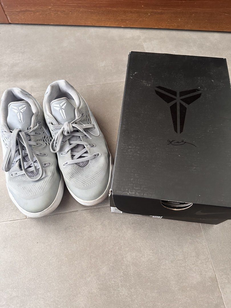Nike Kobe IX Low EM (GS) Grey/White (Category: Sneakers) located in Naga. Submitted by jenni2003 (Listing ID 1435000935, Image 1). Description: Nike Kobe IX Low EM (GS) in grey and white. The shoes come with the original box. Size is 4.5Y, UK 4, CM 23.5, and BR 35. The box has the Kobe logo and signature. The shoes have grey laces and a grey upper. The soles are white..